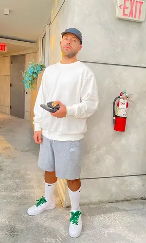 Feid wearing Nike sweatshirt