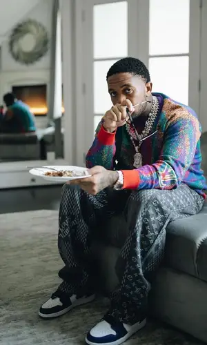 Mustard wearing Louis Vuitton sweater