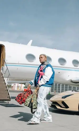 Mustard wearing Louis Vuitton jacket