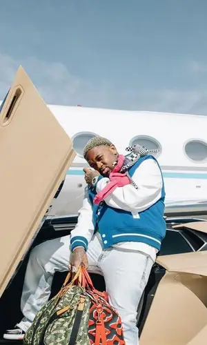 Mustard wearing Louis Vuitton sneakers