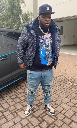 Maxo Kream wearing Warren Lotas t-shirt