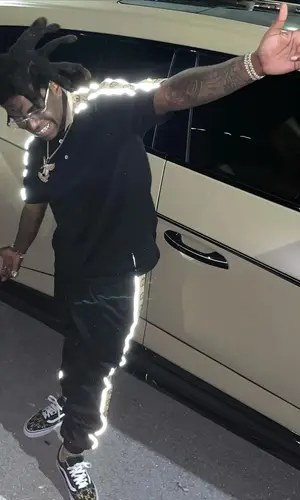 Kodak Black wearing Gucci shirt