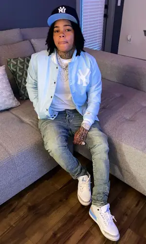 Young M.A wearing New Era cap