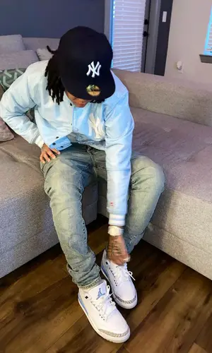 Young M.A’s Outfit in Vintage Jacket, Purple Brand Jeans & New Era Cap (2021)