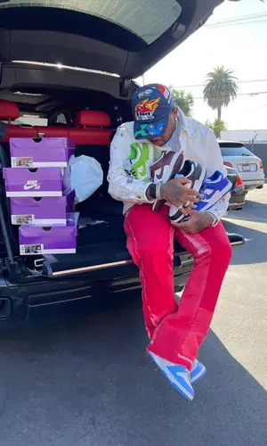Mustard wearing Louis Vuitton cap