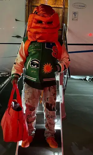 ASAP Bari wearing Ding Yun Zhang hat