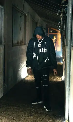 Yo Gotti wearing Amiri jeans