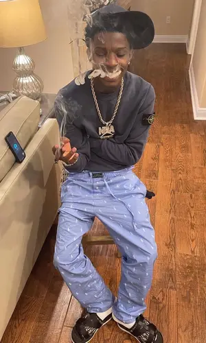 Quando Rondo wearing Stone Island sweatshirt