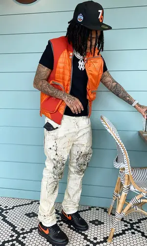 Young M.A wearing Purple Brand jeans