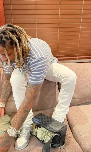 Lil Durk wearing Louis Vuitton bag