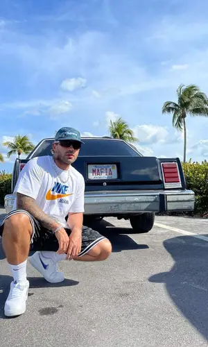 Feid wearing Supreme hat