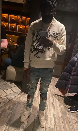 Lil Tjay wearing Amiri jeans