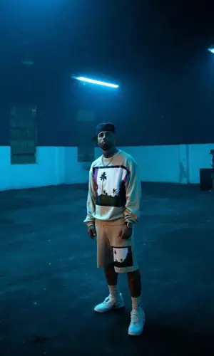 Nicky Jam wearing Dries Van Noten sweatshirt