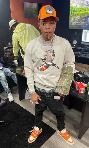Lil Migo wearing Heron Preston sweatshirt