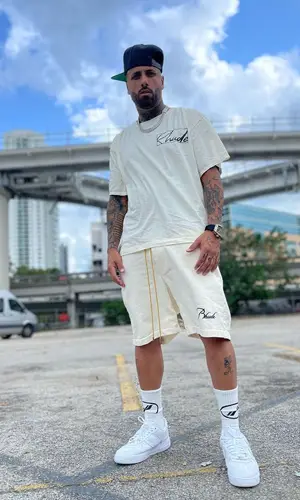 Nicky Jam wearing Rhude t-shirt