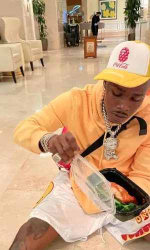 DaBaby wearing Burberry bag
