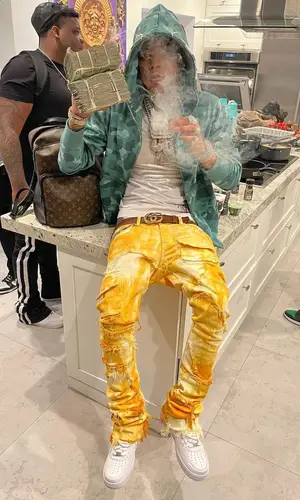 Lil Migo wearing Louis Vuitton backpack