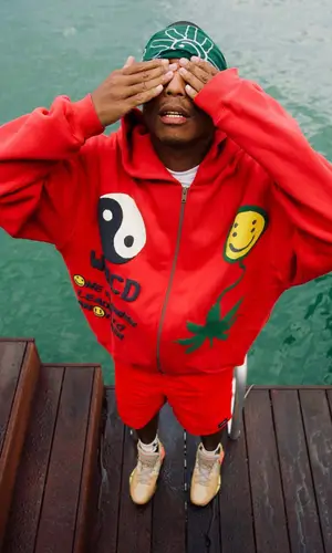 Pharrell Williams wearing Cactus Plant Flea Market sweatshirt