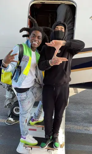 Kodak Black wearing Louis Vuitton backpack