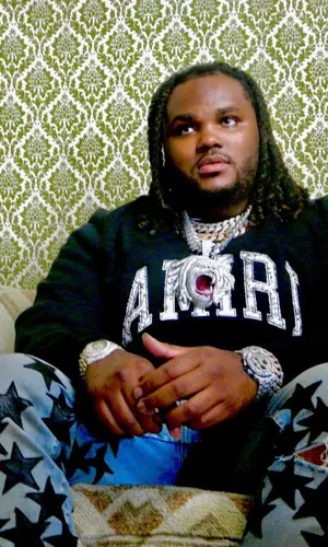 Tee Grizzley wearing Amiri sweatshirt