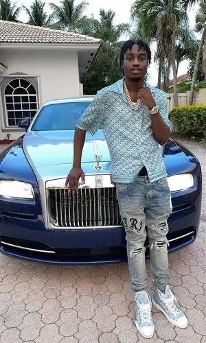 Lil Tjay wearing Dior shirt