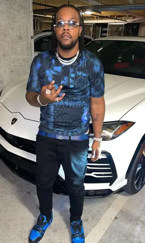 Rowdy Rebel wearing Louis Vuitton belt