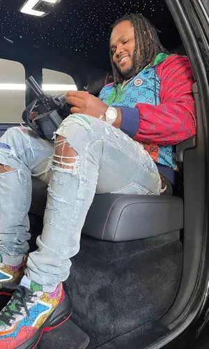 Tee Grizzley wearing Amiri jeans