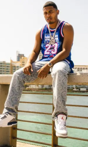 Myke Towers wearing Mitchell & Ness jersey