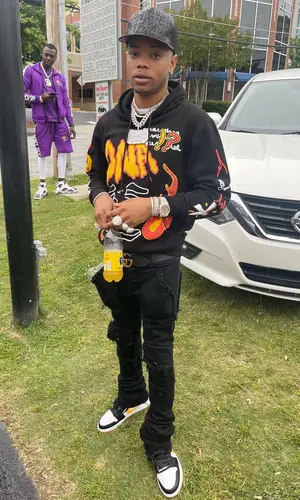 Lil Migo wearing Doing Nothing Average Clothing sweatshirt