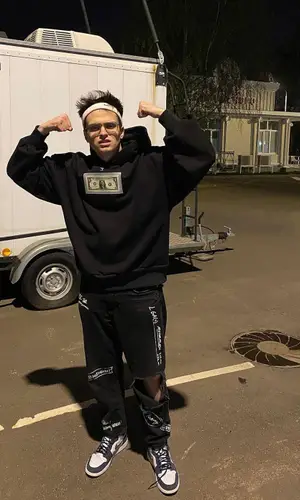Бустер wearing Nike sneakers