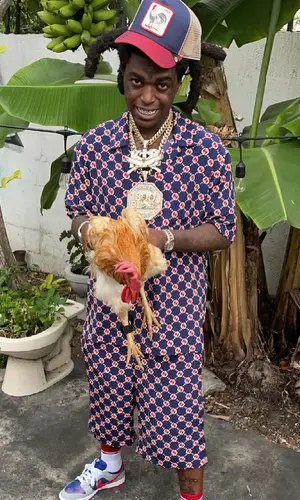Kodak Black wearing Gucci shirt