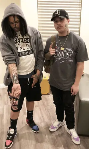 Fredo Santana wearing Savage Squad Records Merch shorts