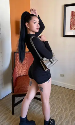 Bella Poarch wearing Prada boots