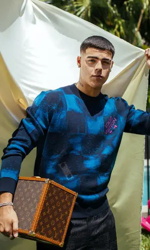 Lunay wearing Louis Vuitton pants