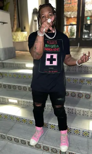 Rowdy Rebel wearing Maison Margiela t-shirt