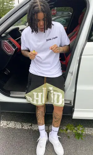 Young M.A wearing Palm Angels t-shirt