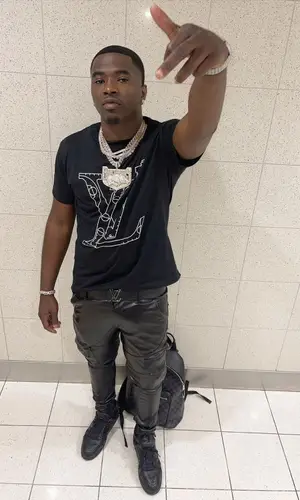 Bankroll Freddie wearing Louis Vuitton backpack