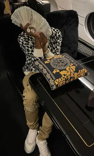 Polo G wearing Louis Vuitton backpack