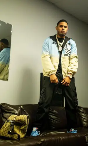 Myke Towers wearing Gucci bag