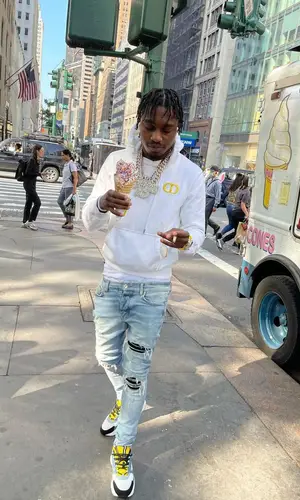 Lil Tjay wearing Amiri jeans