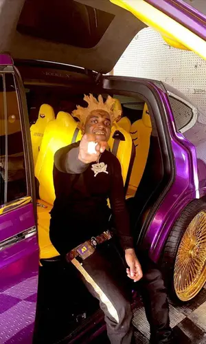 Kodak Black wearing Louis Vuitton wallet