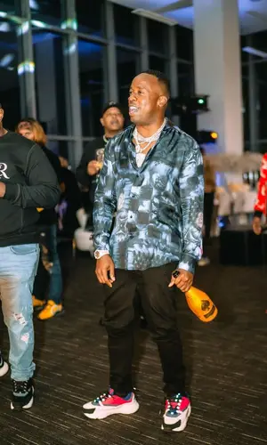 Yo Gotti wearing Amiri jeans