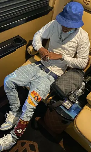 Bizzy Banks wearing Louis Vuitton bag