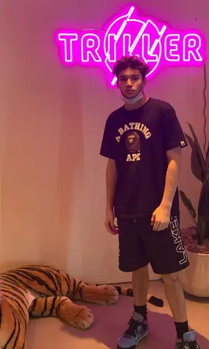 Adin Ross wearing Mitchell & Ness shorts