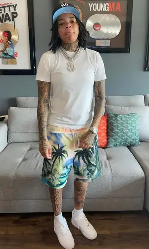 Young M.A wearing Palm Angels shorts