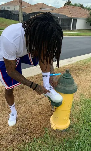J.I.D wearing Vans sneakers