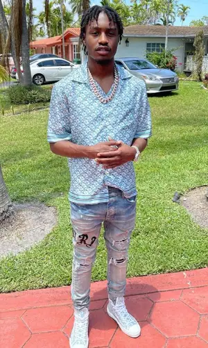 Lil Tjay wearing Dior shirt