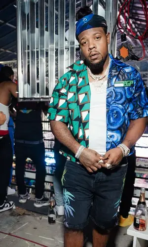 Rowdy Rebel wearing Louis Vuitton belt