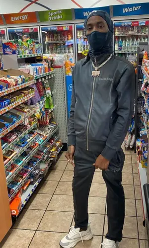 Baby Smoove wearing Palm Angels jacket