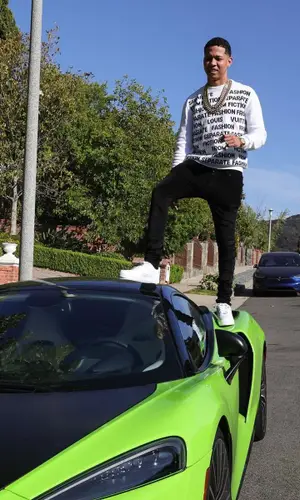 Lil Bibby’s Outfit in Louis Vuitton Sweater, Amiri Jeans & Nike Sneakers (2021)